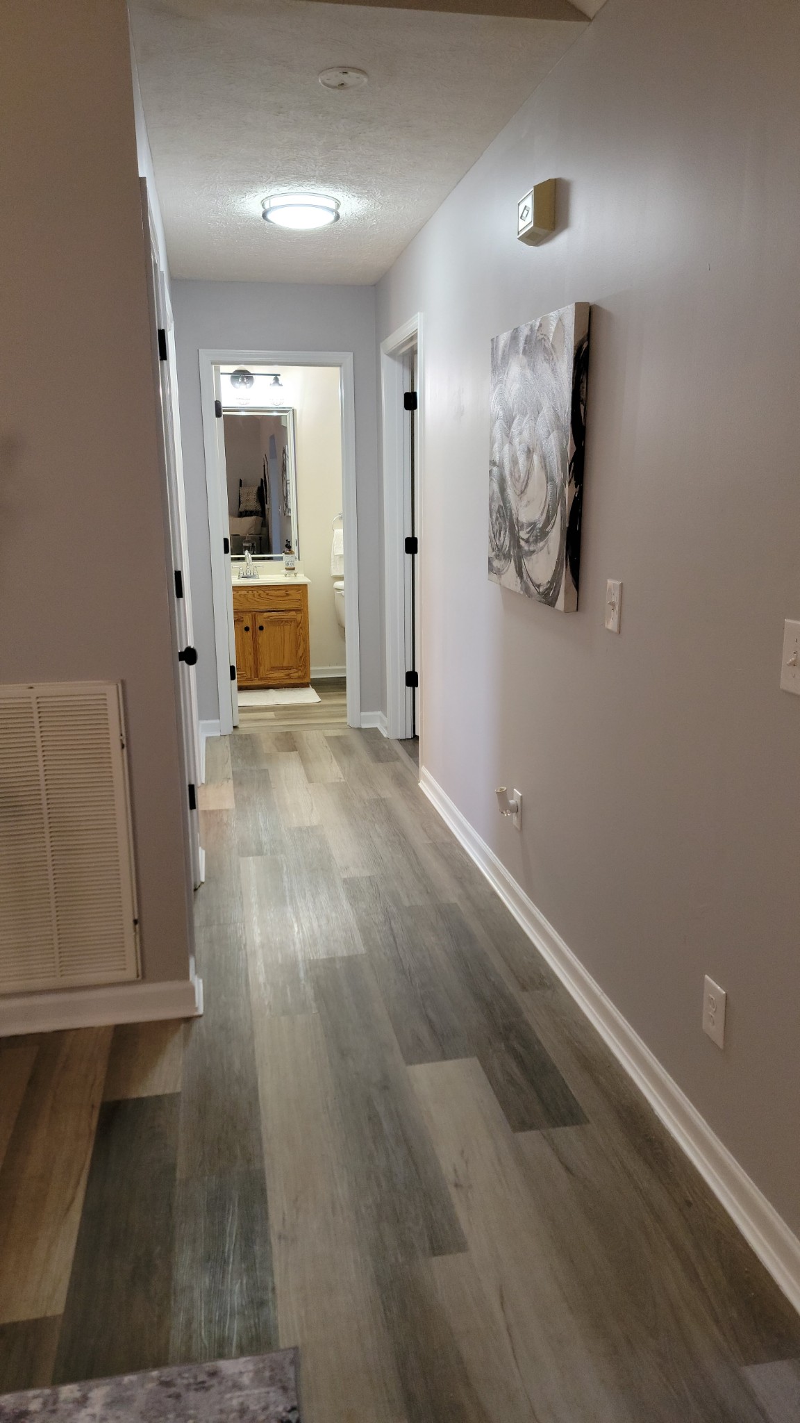 195 Rileys Bend Road Lynchburg, TN 37352 - Photo 11 of 32 a view of a hallway with wooden floor and a cabinet