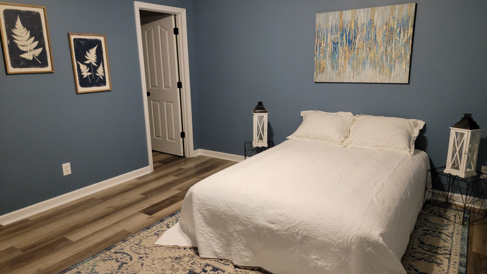 195 Rileys Bend Road Lynchburg, TN 37352 - Photo 20 of 32 a bedroom with a bed and wall painting