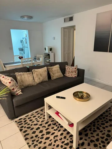 a living room with white and a couch