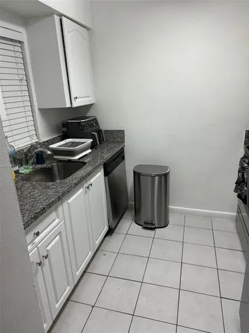 a kitchen with a stove a sink and a cabinets