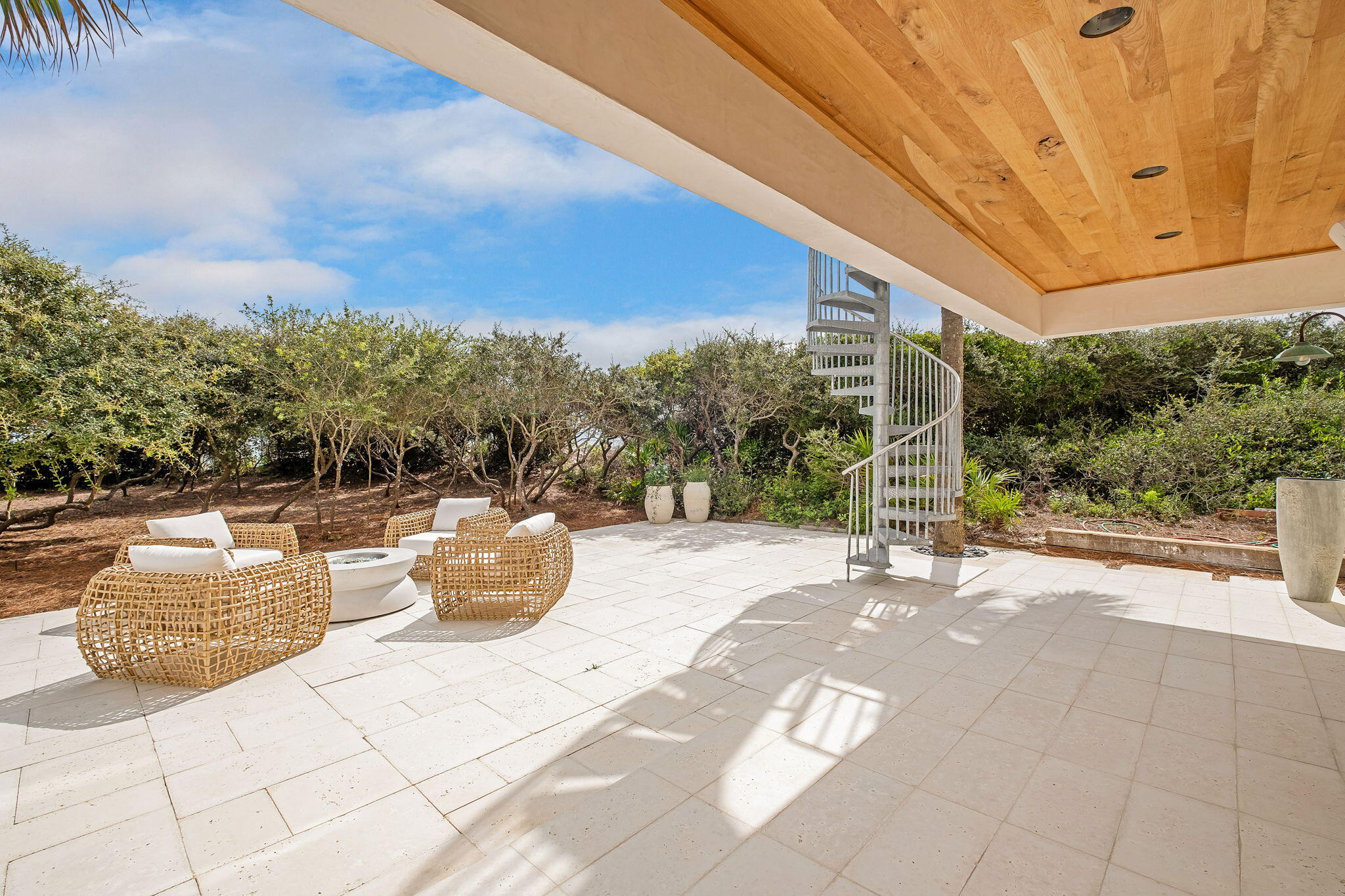 40 Jasmine Circle Santa Rosa Beach, FL 32459 - Photo 94 of 100 a view of a patio with couches and table and chairs and potted plants