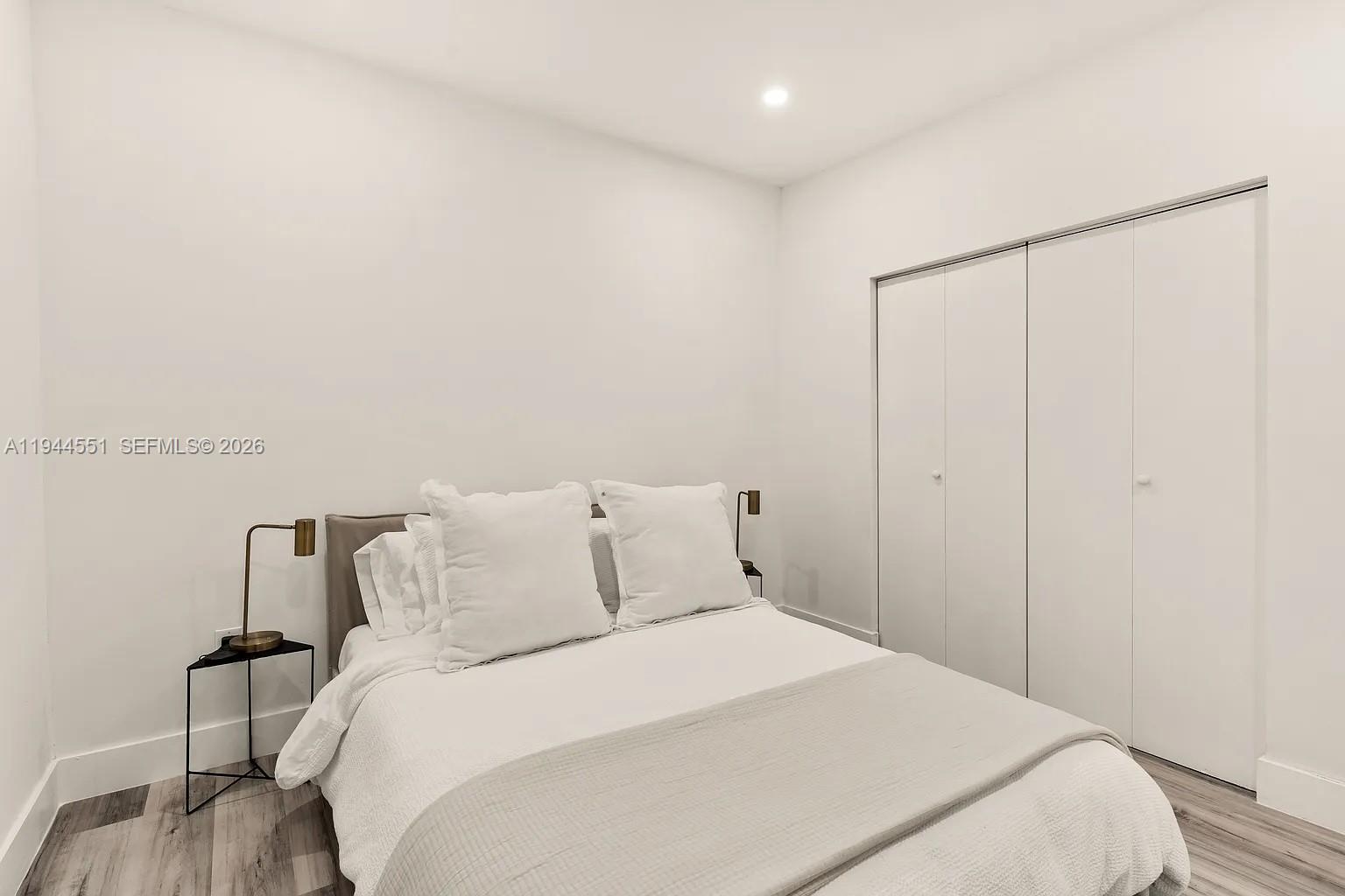 1237 Northwest 33rd Avenue, Unit 1 Miami, FL 33125 - Photo 18 of 22 a bedroom with a bed and a dresser