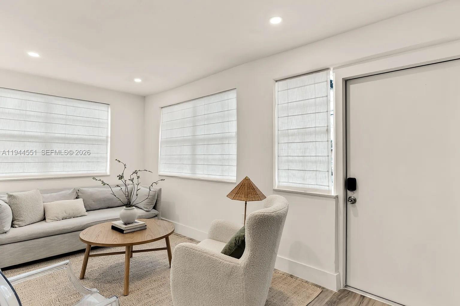 1237 Northwest 33rd Avenue, Unit 1 Miami, FL 33125 - Photo 2 of 22 a living room with furniture and a window