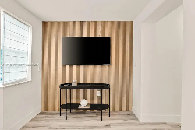 a living room with a fireplace and a flat screen tv