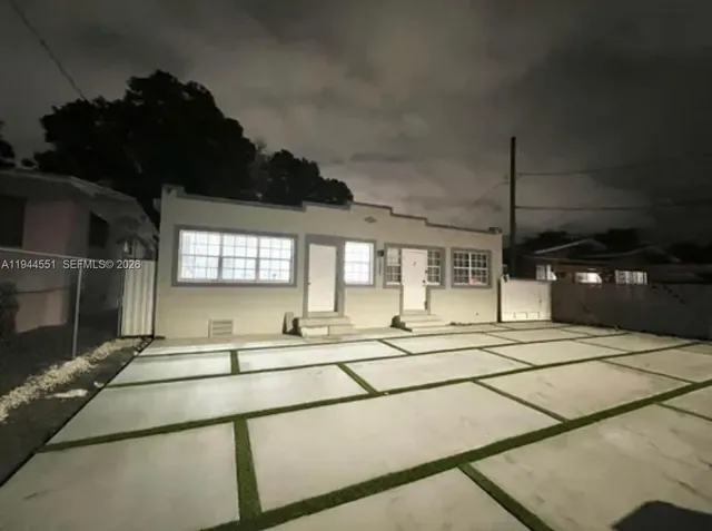 a living room with stainless steel appliances kitchen island granite countertop a sink and cabinets
