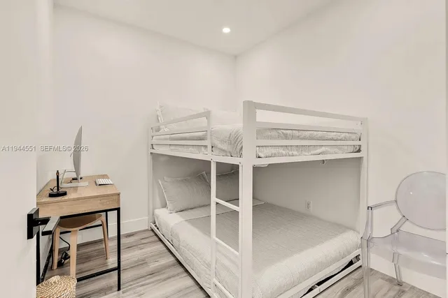 a workspace with wooden floor and windows