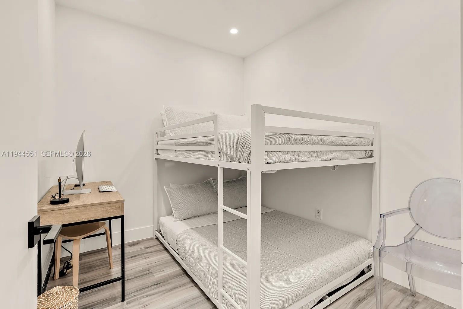 1237 Northwest 33rd Avenue, Unit 1 Miami, FL 33125 - Photo 6 of 22 a workspace with wooden floor and windows