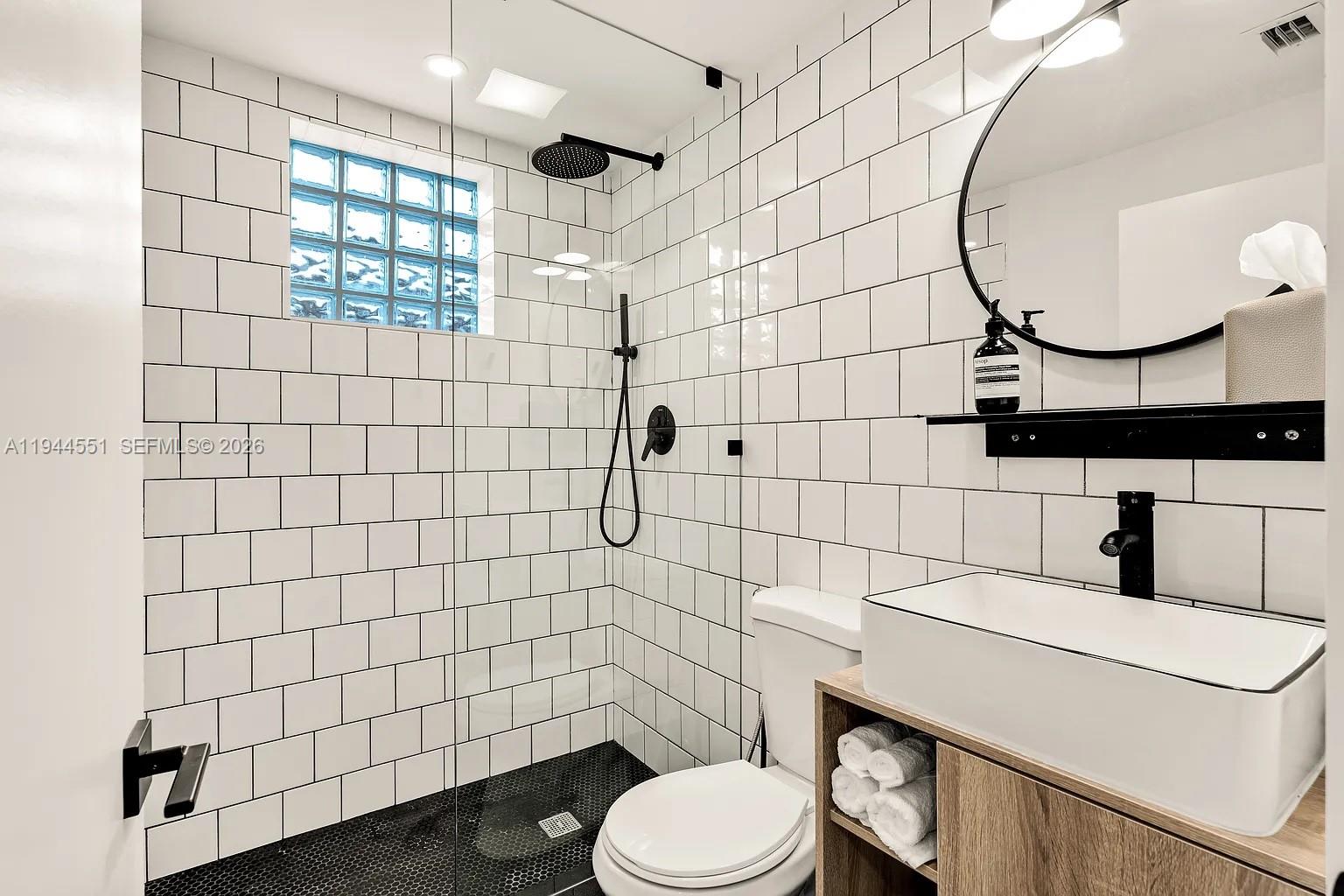 1237 Northwest 33rd Avenue, Unit 1 Miami, FL 33125 - Photo 8 of 22 a bathroom with a sink toilet and shower