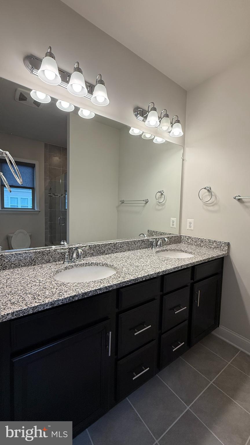 1949 Greenbriar Hall Road Dumfries, VA 22026 - Photo 14 of 26 a bathroom with a granite countertop sink and a mirror