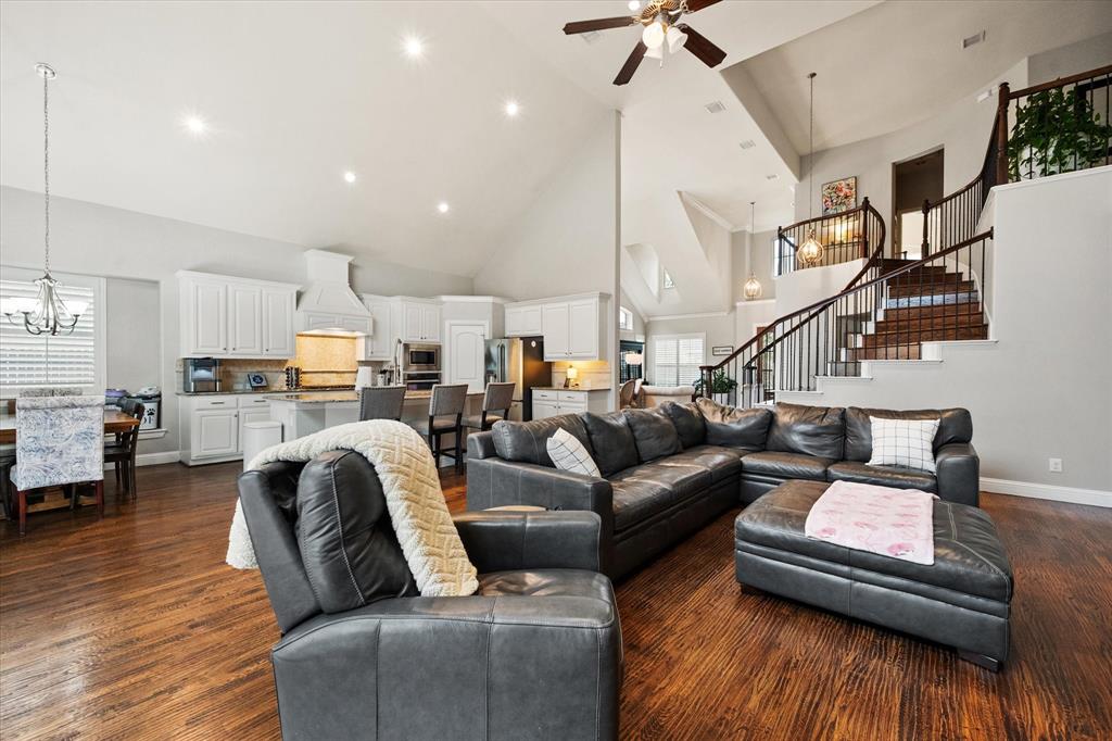 6713 Matador Ranch Road North Richland Hills, TX 76182 - Photo 15 of 39 Living area featuring suspended lighting, ceiling fan, dark wood finished floors, and vaulted ceiling