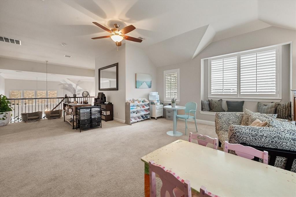6713 Matador Ranch Road North Richland Hills, TX 76182 - Photo 23 of 39 Carpeted living room featuring ceiling fan and lofted ceiling