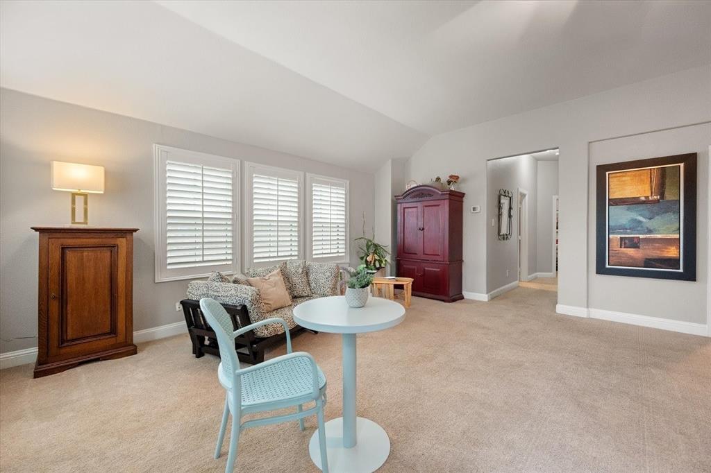 6713 Matador Ranch Road North Richland Hills, TX 76182 - Photo 24 of 39 Living area with light carpet and lofted ceiling
