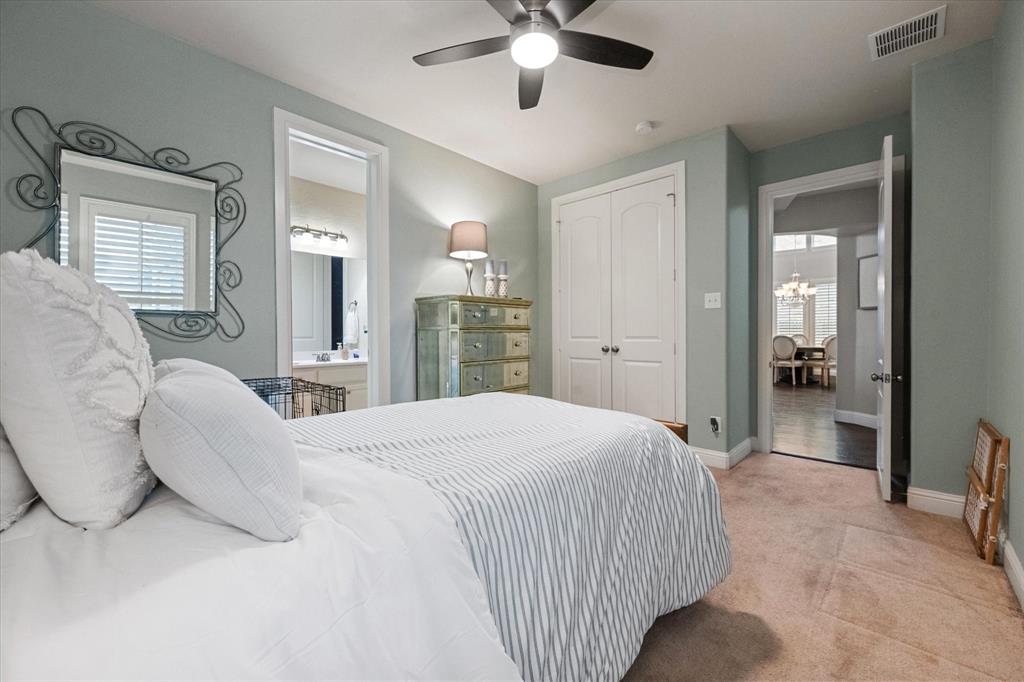 6713 Matador Ranch Road North Richland Hills, TX 76182 - Photo 29 of 39 Bedroom with light colored carpet, ensuite bathroom, a ceiling fan, and a closet