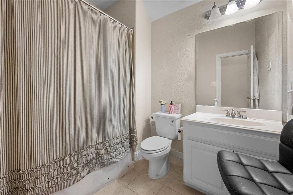6713 Matador Ranch Road North Richland Hills, TX 76182 - Photo 33 of 39 Bathroom with a textured wall, vanity, a shower with curtain, and light tile patterned flooring