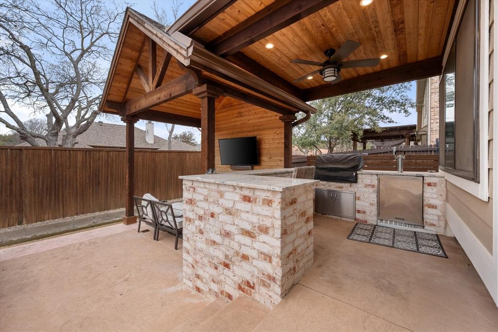 6713 Matador Ranch Road North Richland Hills, TX 76182 - Photo 34 of 39 View of patio featuring area for grilling, TV and a ceiling fan