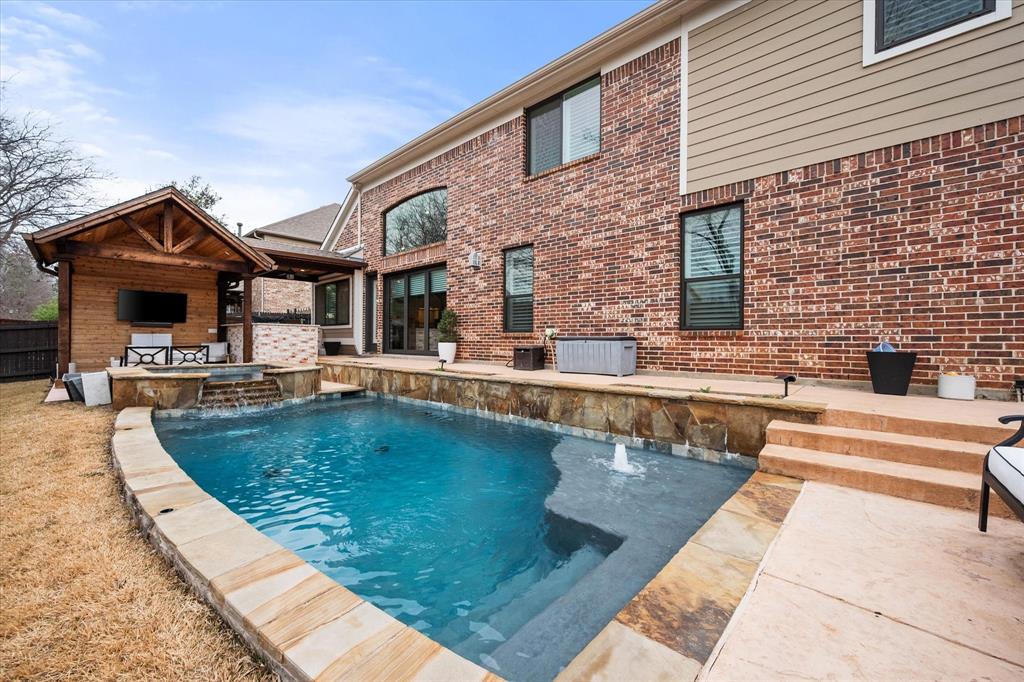6713 Matador Ranch Road North Richland Hills, TX 76182 - Photo 37 of 39 Integrated pool / spa with a fireplace and a patio