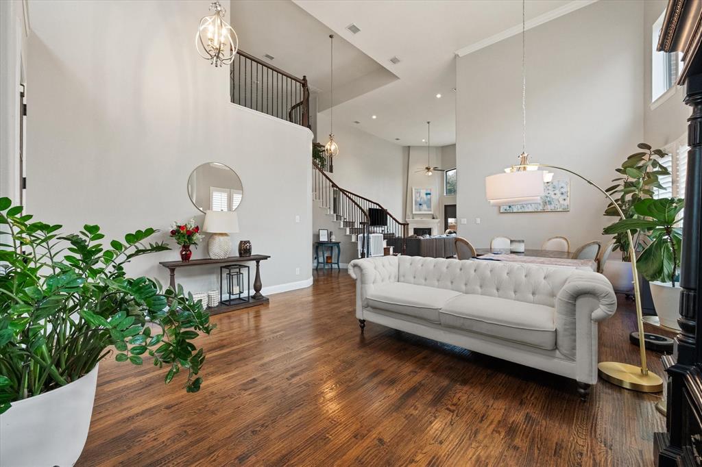 6713 Matador Ranch Road North Richland Hills, TX 76182 - Photo 4 of 39 Living room featuring wood-style flooring, a chandelier, and a high ceiling