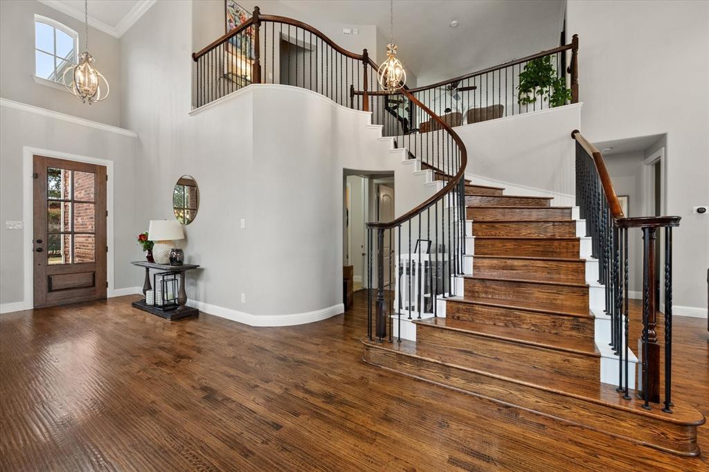 6713 Matador Ranch Road North Richland Hills, TX 76182 - Photo 8 of 39 Entryway with hanging lights, a high ceiling, and hardwood / wood-style floors
