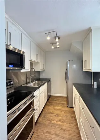 a large kitchen with a stove and a sink