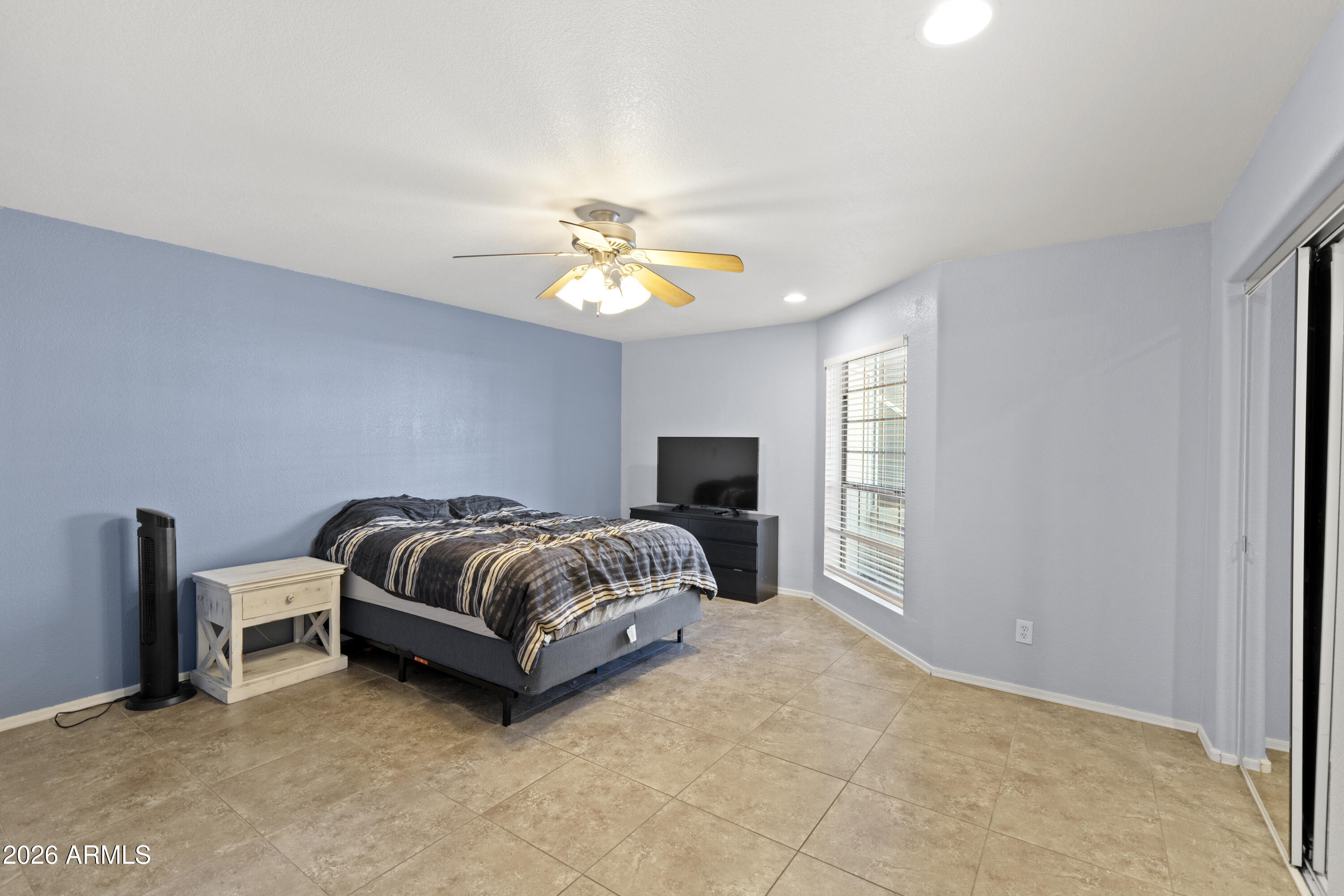 1505 North Center Street, Unit 115 Mesa, AZ 85201 - Photo 8 of 24 a spacious bedroom with a bed and a chandelier