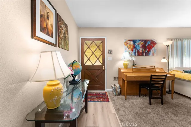 a living room with furniture a rug and a wall painting