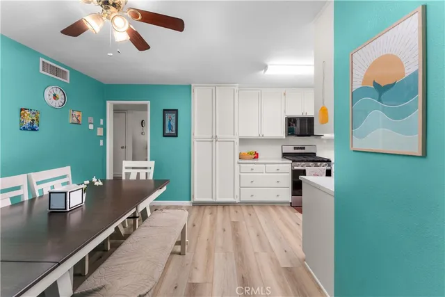 a kitchen with stainless steel appliances kitchen island granite countertop a refrigerator a stove and a sink with garden view