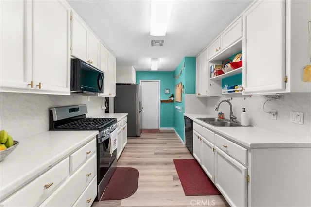a kitchen with stainless steel appliances granite countertop a stove and a sink