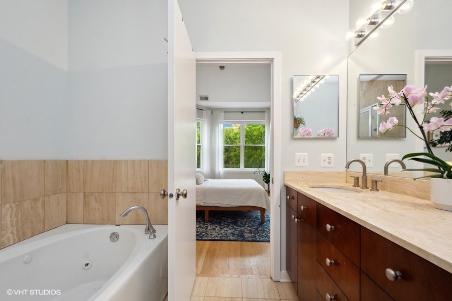 844 East 45th Street Chicago, IL 60653 - Photo 17 of 26 a bathroom with a tub sink and mirror