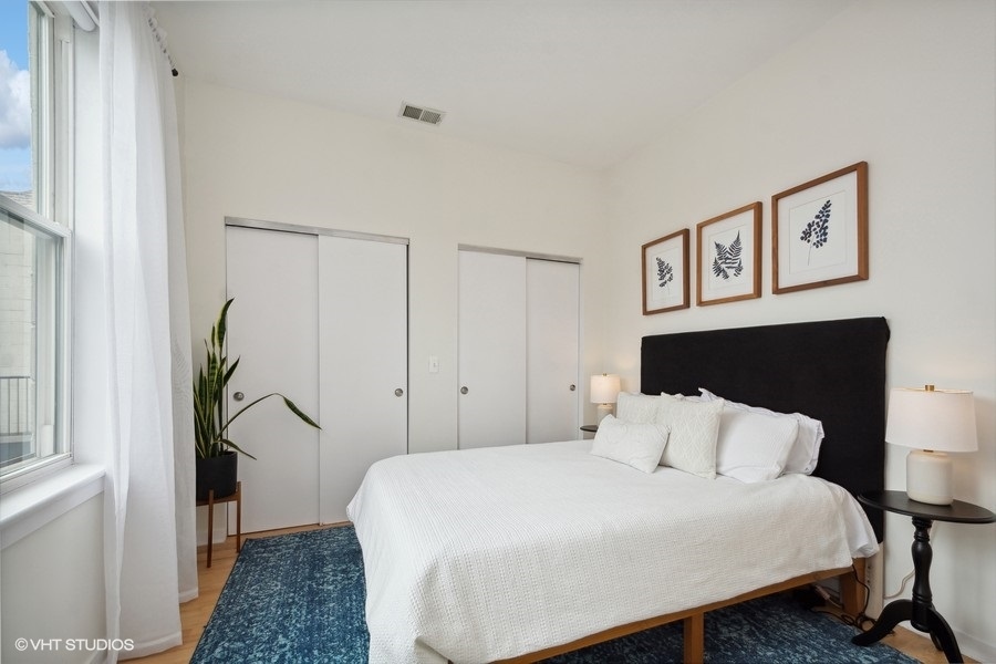 844 East 45th Street Chicago, IL 60653 - Photo 18 of 26 a bedroom with a bed table and a window