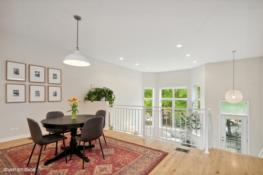 844 East 45th Street Chicago, IL 60653 - Photo 7 of 26 a dining room with furniture a chandelier and wooden floor