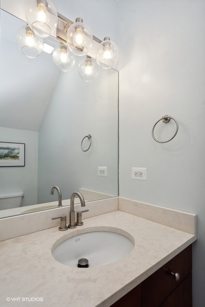 844 East 45th Street Chicago, IL 60653 - Photo 10 of 26 a bathroom with a sink vanity and a mirror
