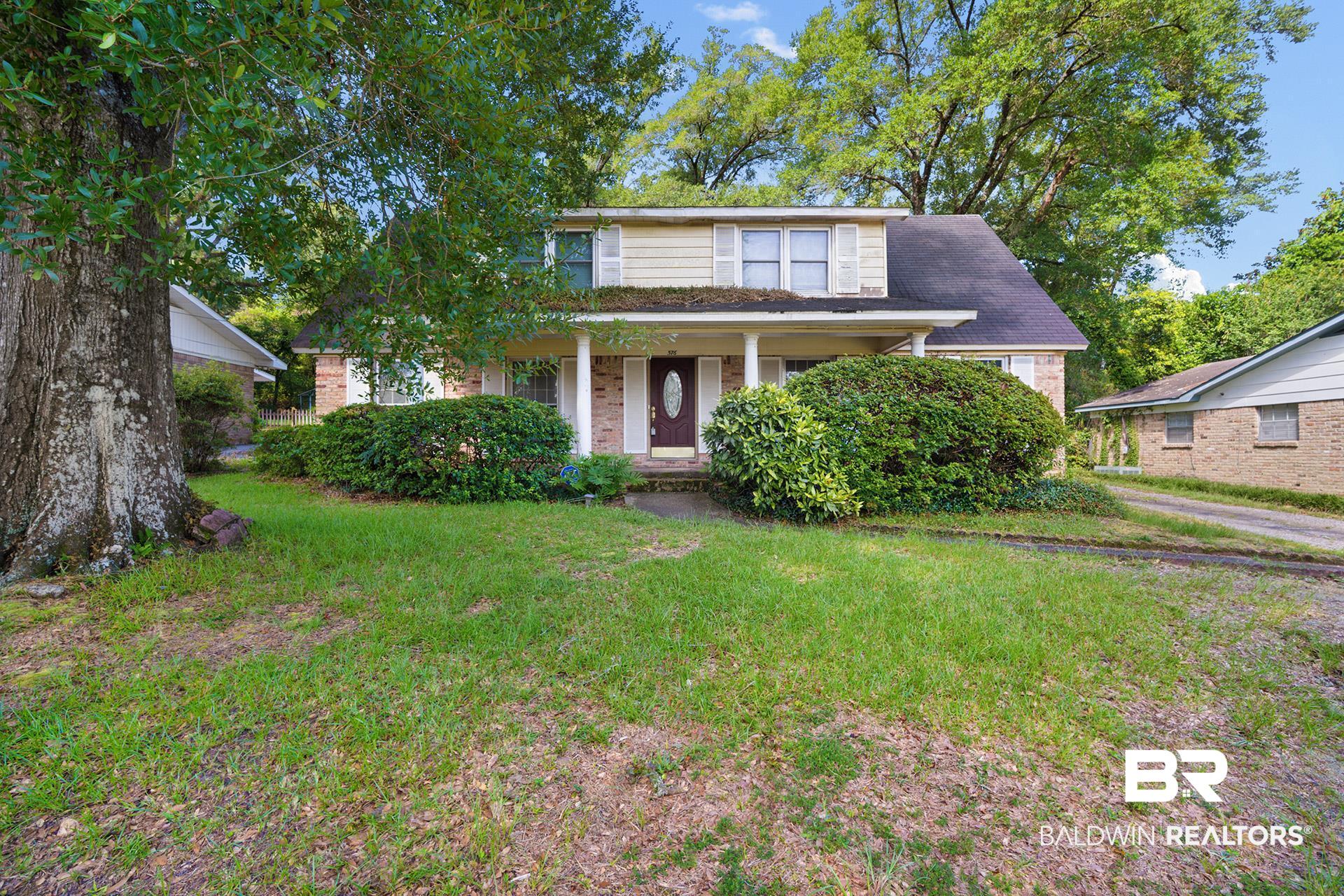 576 Markham Drive Mobile, AL 36609 - Photo 1 of 18 Traditional-style house with a porch, a front lawn, and brick siding