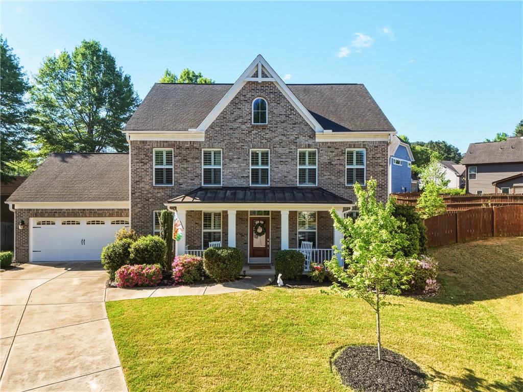 a front view of a house with garden