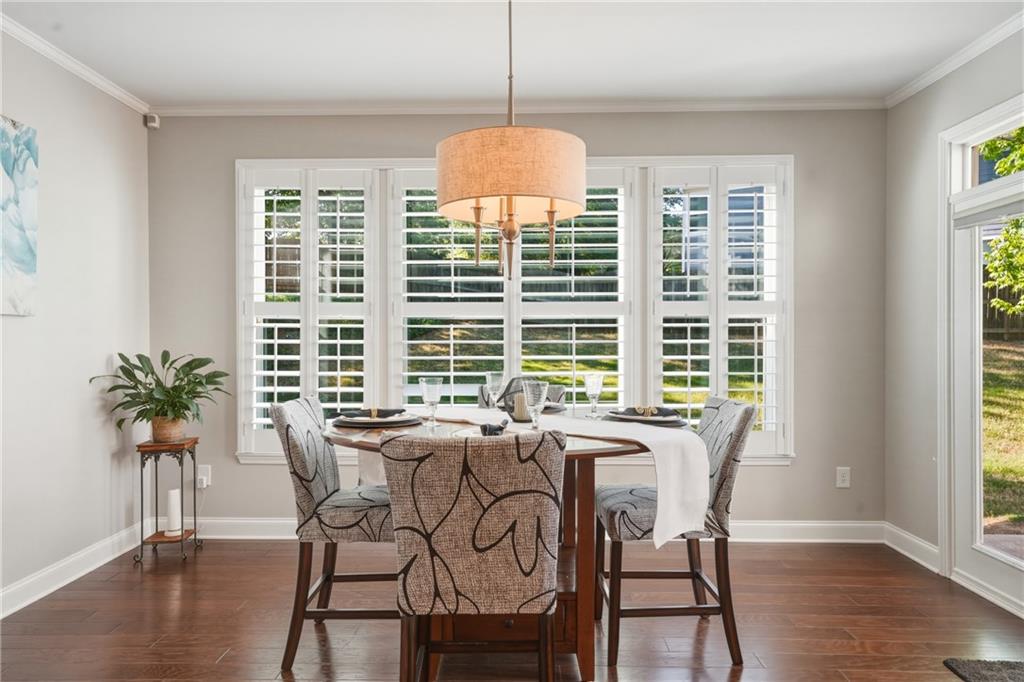 3330 Camelot Way Cumming, GA 30040 - Photo 14 of 47 a view of a dining room with furniture window and wooden floor