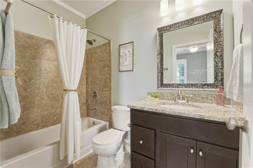 3330 Camelot Way Cumming, GA 30040 - Photo 20 of 47 a bathroom with a granite countertop sink toilet and shower