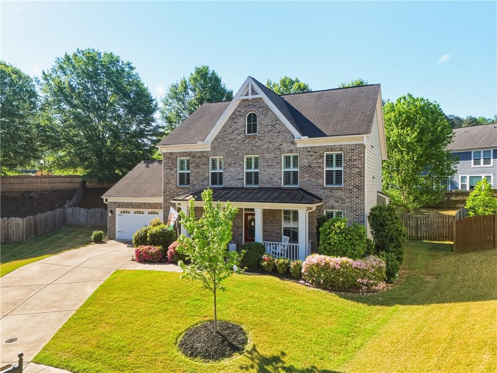 3330 Camelot Way Cumming, GA 30040 - Photo 2 of 47 a front view of a house with a yard