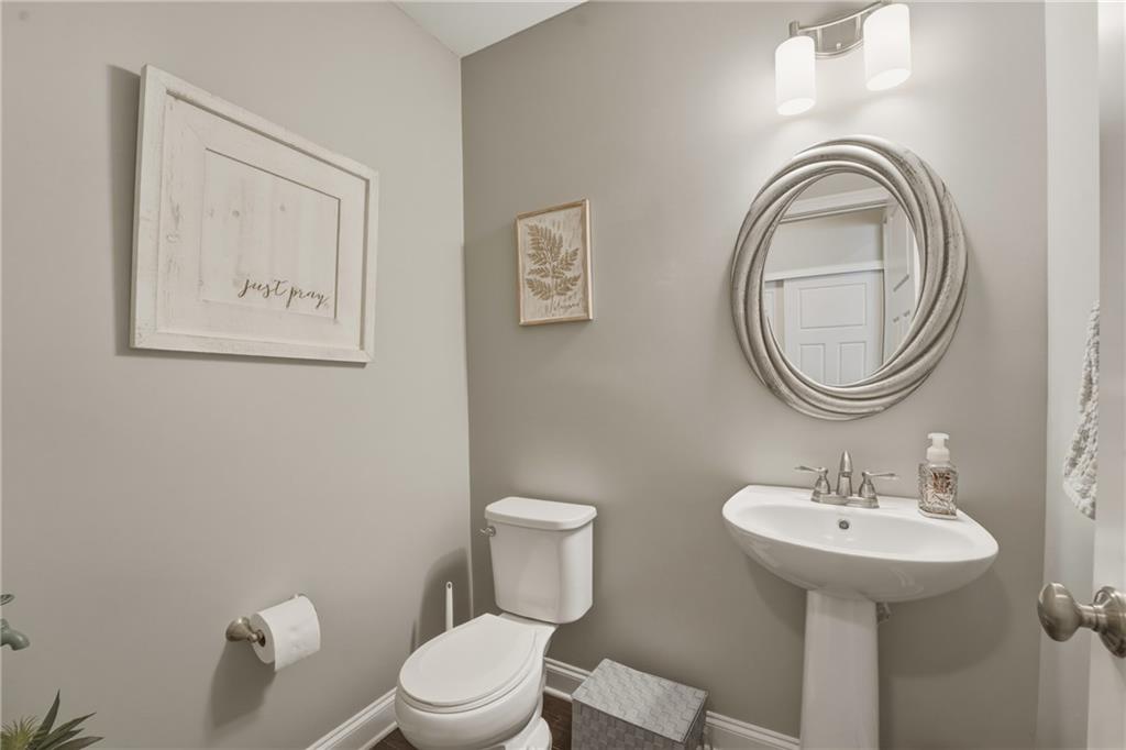3330 Camelot Way Cumming, GA 30040 - Photo 21 of 47 a bathroom with a toilet a sink and mirror