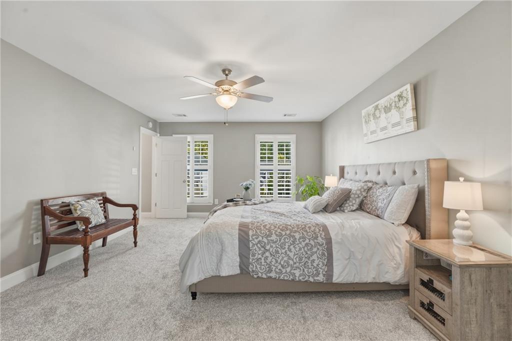 3330 Camelot Way Cumming, GA 30040 - Photo 25 of 47 a spacious bedroom with a bed and a chair