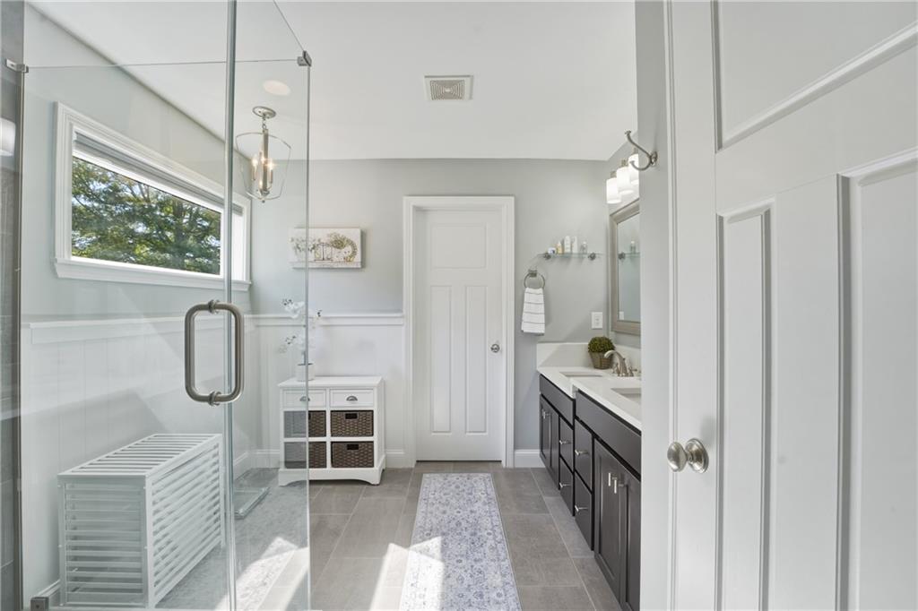 3330 Camelot Way Cumming, GA 30040 - Photo 27 of 47 a bathroom with a granite countertop tub shower sink mirror and vanity