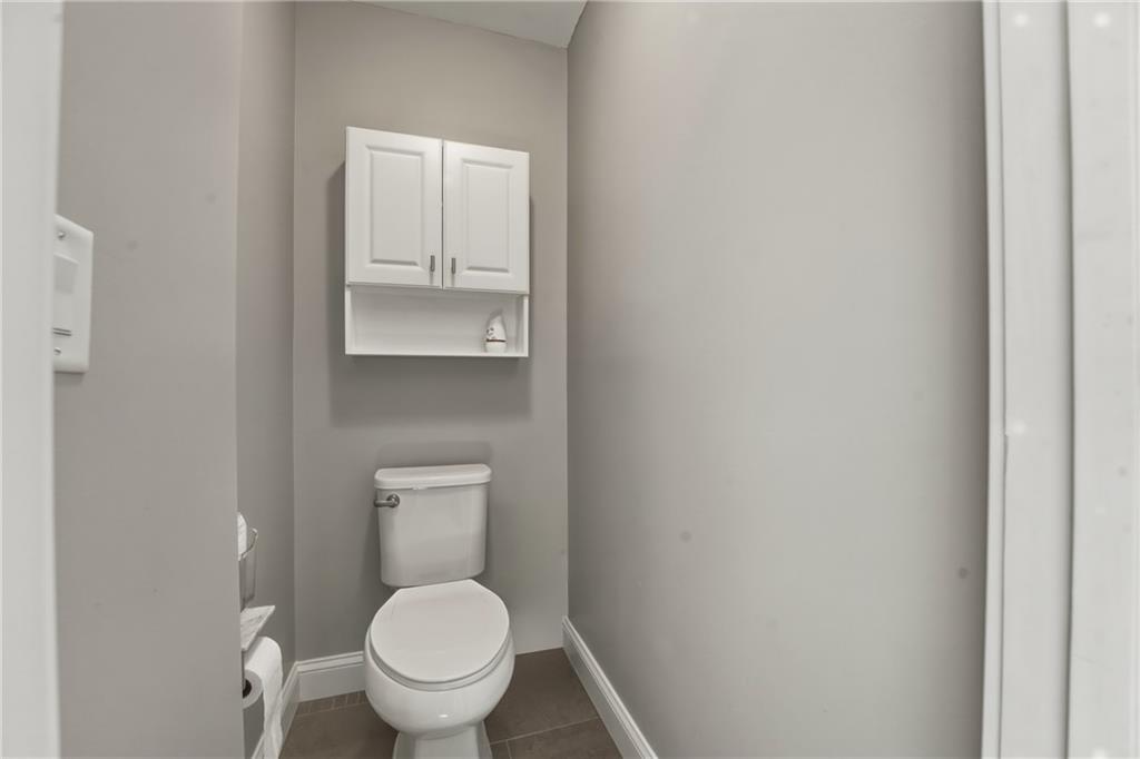 3330 Camelot Way Cumming, GA 30040 - Photo 29 of 47 a white toilet sitting in a bathroom and a sink
