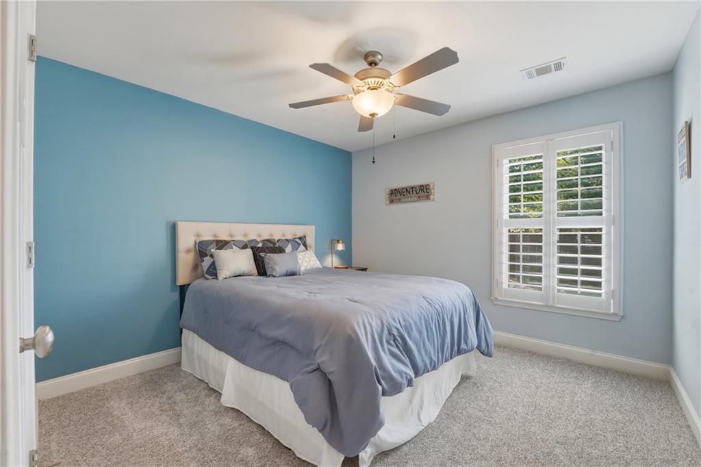 3330 Camelot Way Cumming, GA 30040 - Photo 31 of 47 a spacious bedroom with a bed and a window