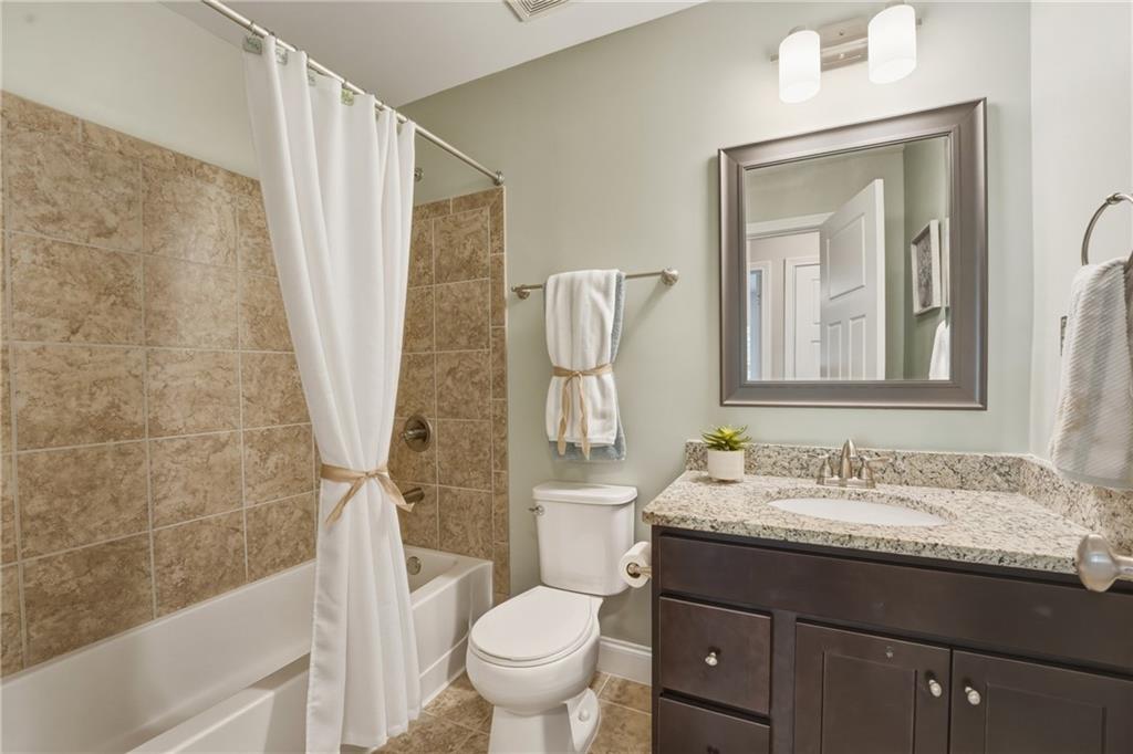 3330 Camelot Way Cumming, GA 30040 - Photo 32 of 47 a bathroom with a granite countertop sink toilet and shower