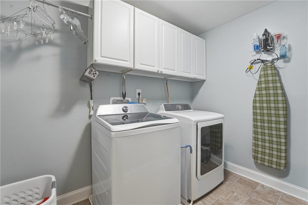 3330 Camelot Way Cumming, GA 30040 - Photo 34 of 47 a utility room with dryer and washer