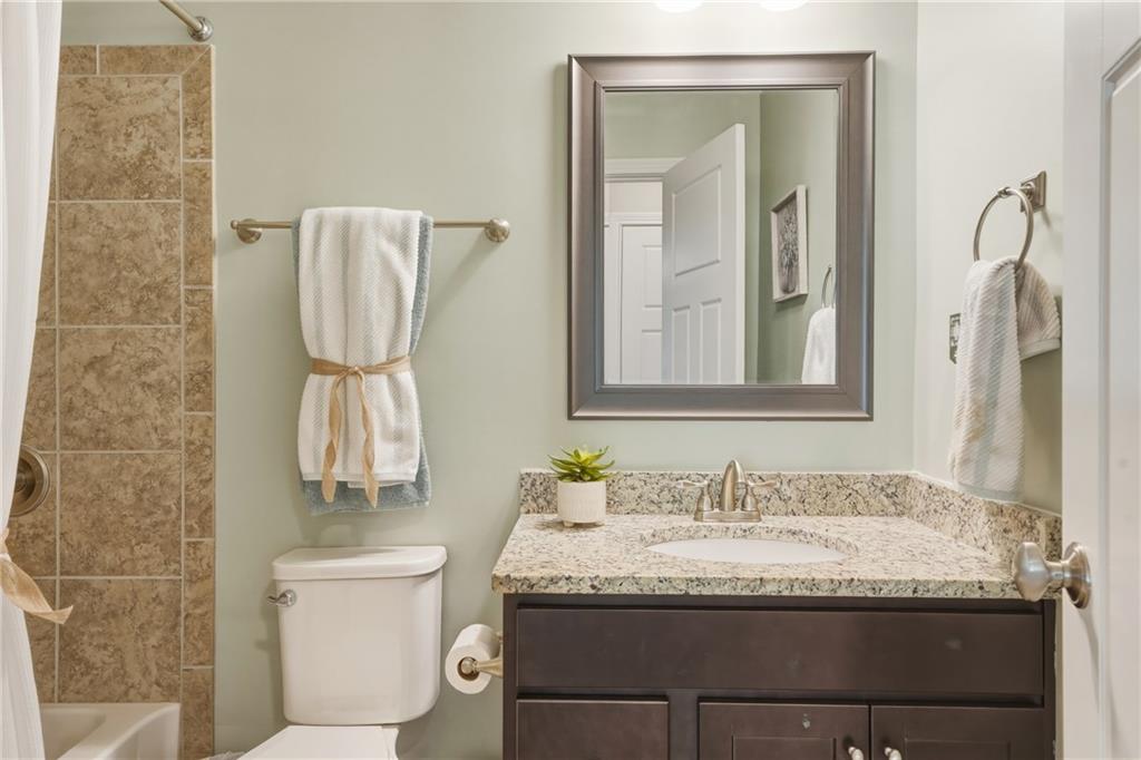 3330 Camelot Way Cumming, GA 30040 - Photo 35 of 47 a bathroom with a granite countertop sink and a mirror