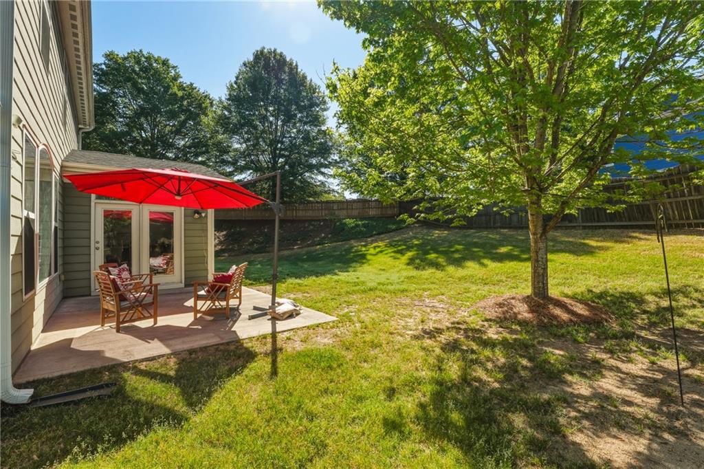 3330 Camelot Way Cumming, GA 30040 - Photo 41 of 47 a view of a swimming pool with a table and chairs under an umbrella