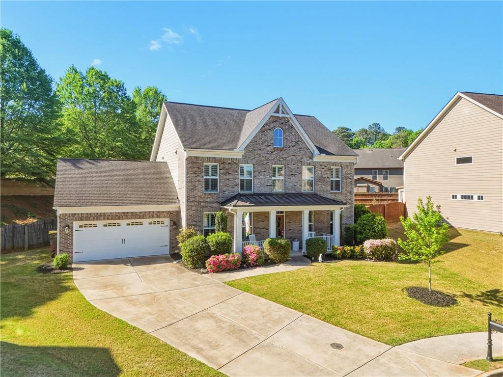 3330 Camelot Way Cumming, GA 30040 - Photo 47 of 47 a front view of a house with a garden