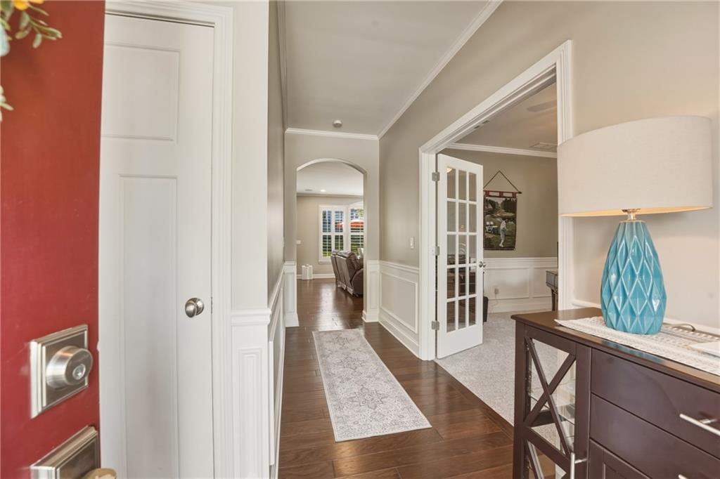 3330 Camelot Way Cumming, GA 30040 - Photo 6 of 47 a view of a hallway with wooden floor windows and livingroom