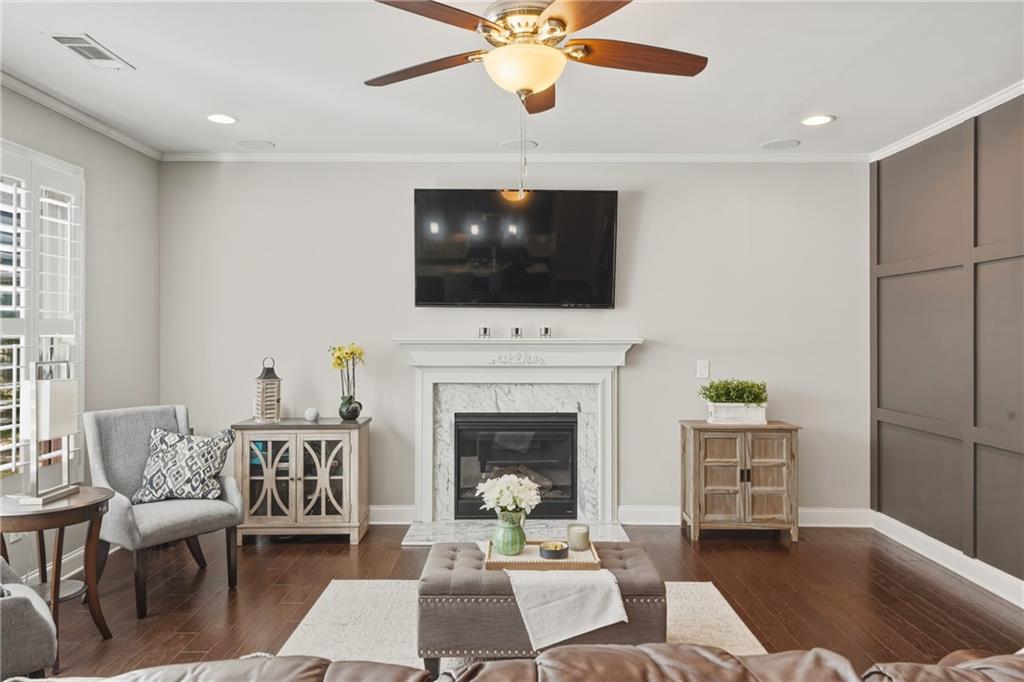 3330 Camelot Way Cumming, GA 30040 - Photo 8 of 47 a living room with furniture a fireplace and a flat screen tv