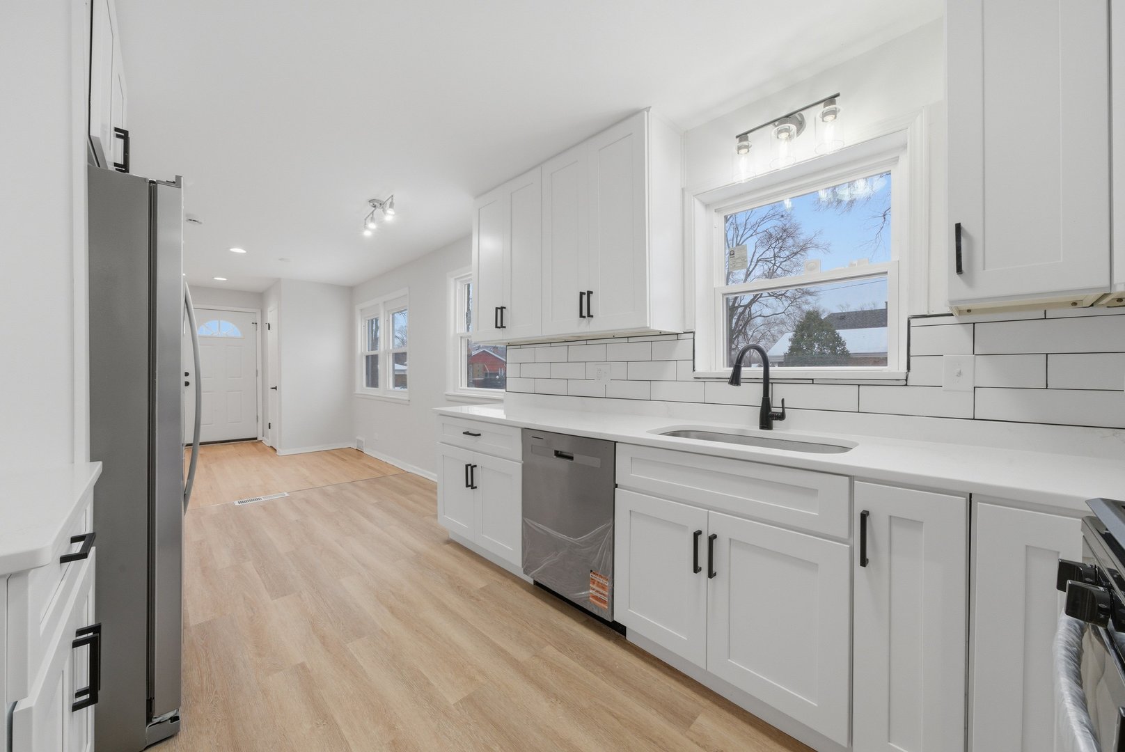 12358 South Lowe Avenue Chicago, IL 60628 - Photo 1 of 14 a kitchen with white cabinets and sink