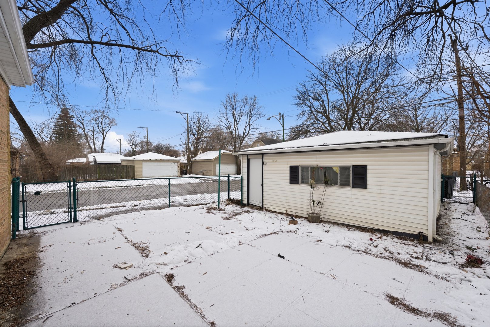 12358 South Lowe Avenue Chicago, IL 60628 - Photo 12 of 14 a view of a house with a snow in the yard